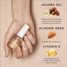 Load image into Gallery viewer, A hand with healthy nails holding a bottle of Solar Oil and list of ingredients
